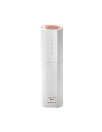 White skincare bottle with pink cap on a light pink background