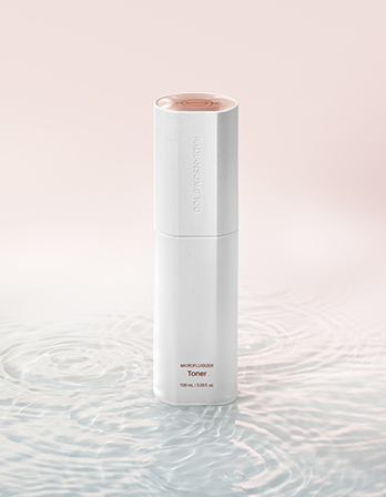 White skincare bottle with pink cap on a light pink background