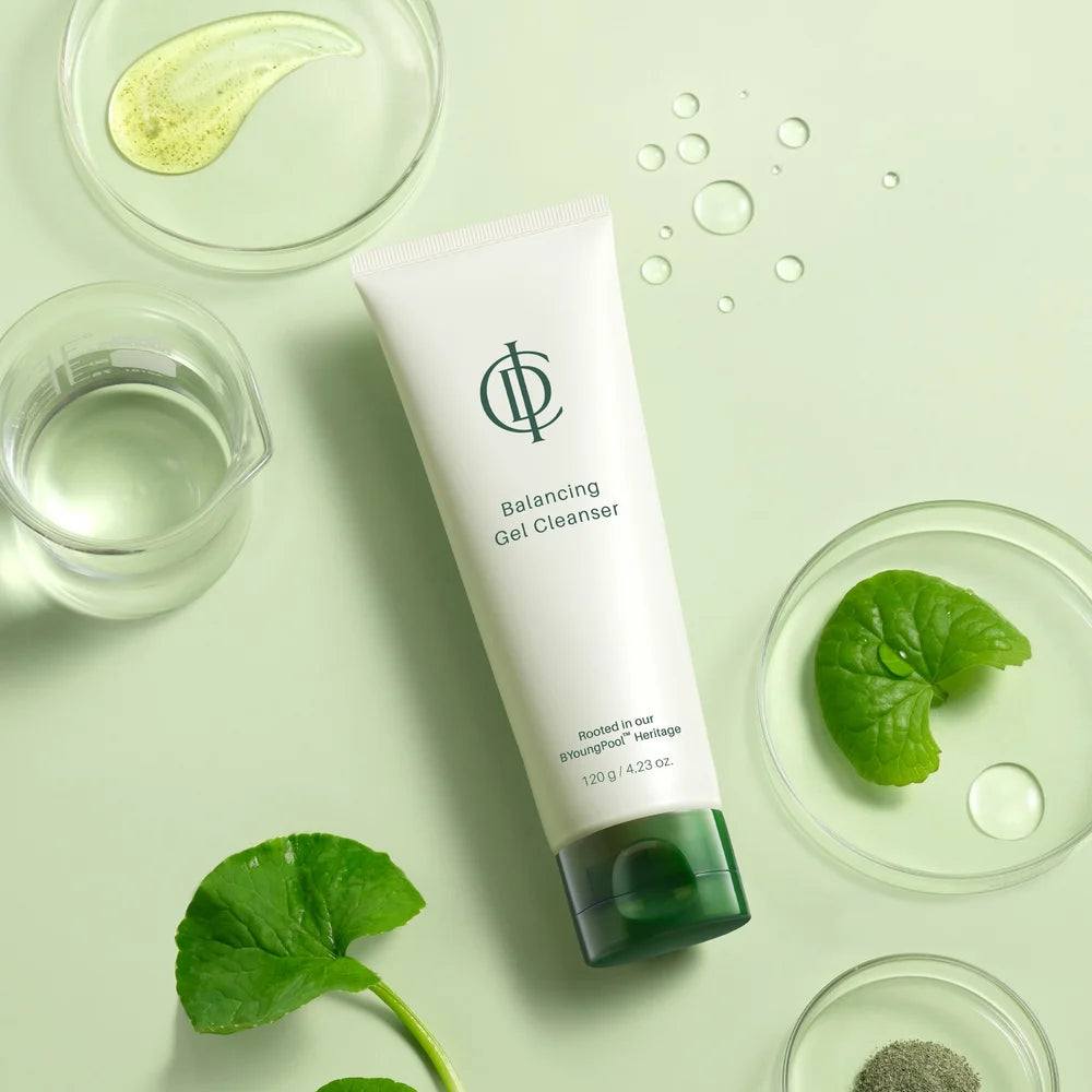 Tube of 'Balancing Gel Cleanser' with green leaves and glass containers on a light green background