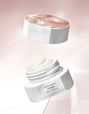 Two skincare cream jars with visible brand names on a soft pink background